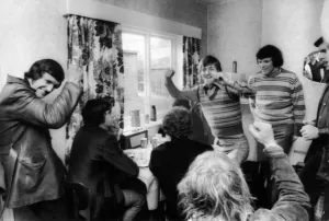 Leeds United players celebrate after hearing the FA Cup semi-final draw on the radio in a