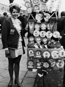 Leeds United supporter Mrs Barbra Pewte seen here standing beside a rosette stall outside