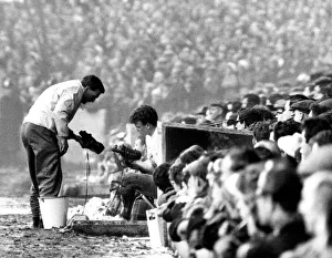 Leeds v. Chelsea. Billy Bremner of Leeds inspects the new boots with the trainer