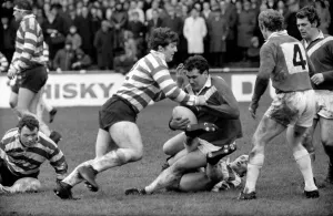 Leigh v. Oldham. Leigh prop forward Chisnall is grounded by Oldham forwards McCormack