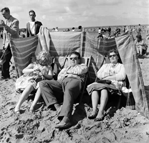 The Lemm family of Castleford, Yorkshire sit behind the protection of their windbreaker
