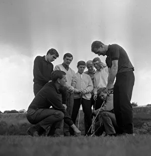 Len Badger and Mick Jones of Sheffield United along with other players get a few handy