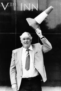 00244 Prints: Len Shackleton Sunderland, Newcastle and England footballer holds a traffic cone above