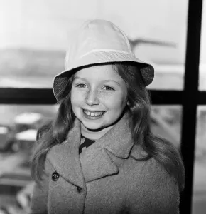 Coat Prints: Lena Zavaroni, aged 10, pictured at London Heathrow Airport, to catch flight to Glasgow