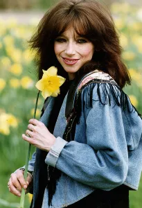Lena Zavaroni singer with daffodil flower outisde her house in London. April 1993