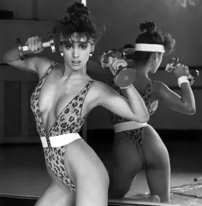 Leopardskin lace body stocking, elastic clip belt and headband. January 1987 P006276