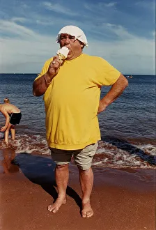 Ice Cream Prints: Les Dawson Comedian on Beach eating Ice-Cream A©mirrorpix
