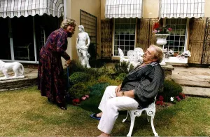 Les Dawson Comedian with wife in garden pretending he is exhausted