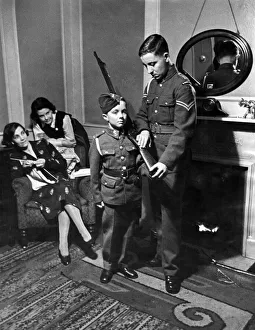 Leslie Chegwin is given some tips on rifle drill, he is only 12 but he joined the R. A