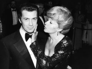Lewis Collins Actor has his face caressed by Ingrid Pitt at the premiere of his film