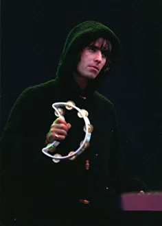 Liam Gallagher playing the tambourine during the Oasis concert at Balloch Country Park