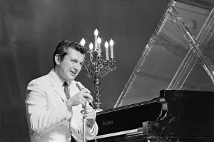 00989 Prints: Liberace entertains the audience at The Royal Variety Show held in the presence of her