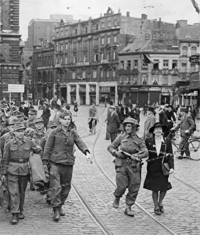 Belgium Prints: Liberated Antwerp, Belgium. Picture shows a local woman helping a British