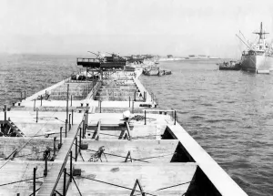 00125 Prints: A liberty ship inside the outer wall of the Mulberry harbour just off of Gold beach