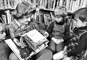 Libraries Prints: Library Assistant Christine Maley telling a story to Karen Miller