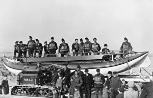 Lieutenant Commander G. R. Cousins of the Royal Navy (in front of boat)