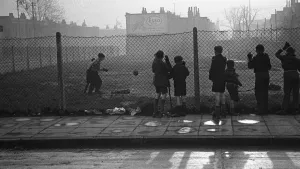 Life in the Mirror Our Gang. 19th January 1954 Boys playing football watched on by