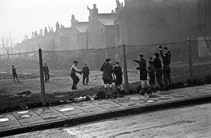 00484 Prints: Life in the Mirror Our Gang. 19th January 1954 Boys playing football watched on by