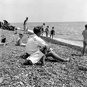 00014 Prints: Lifeguard George Wheeler and his dog - Brighton Life - Saver. July 1952 C3455