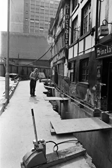The lifting of the Old Shambles in the centre of Manchester begins with a lift of about