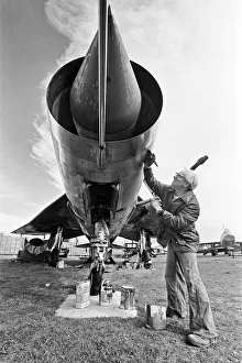 A Lightning aircraft being painted and restored by a workman at the Midland Air Museum