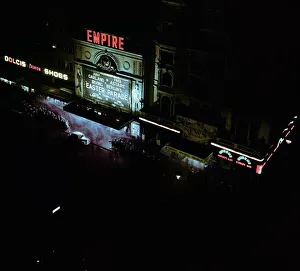 Illumination Prints: Lights of london. Empire cinema illuminated as crowds queue to watch the film