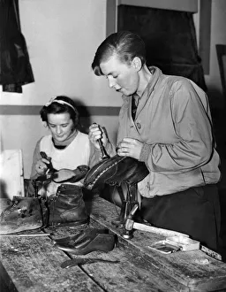 00781 Prints: Lincoln Camp School. One of the females staff of the Lincoln Camp School repairing her