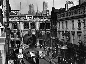 Towns Prints: Lincoln, Lincolnshire. The cathedral built on a hill towers over the High Street