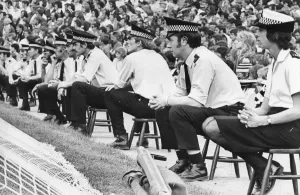 A line of policemen and women control the Newcastle United fans at St James Park 21
