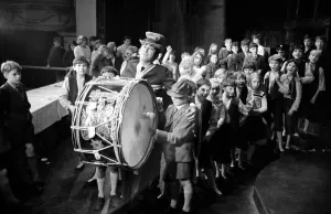 00185 Prints: Lionel Bart who wrote Oliver'plays the big drum from the Irish Guards as he
