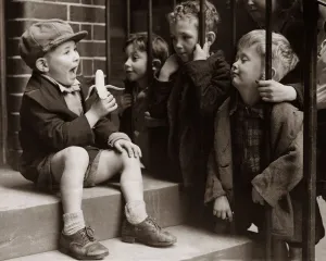 Banana Prints: A Little boy holding a banana whilst other children gaze longingly at it hoping to try a
