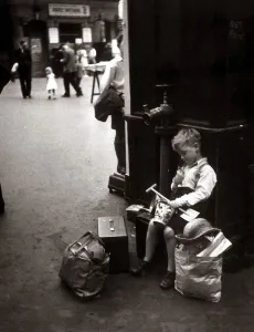 A little boy Kenneth James waits for his train at the station ready to take him home