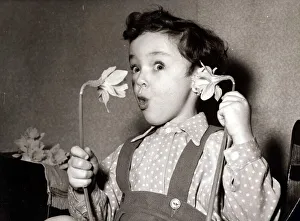 Surprise Prints: Little boy, Paul, hold flowers daffodils up to his ear and mouth like a telephone