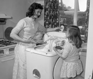 Little Christine Eccles likes to help her mother Doreen with the washing which is much