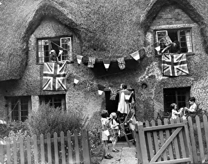Little evacuees hang out bunting and flags in a Warwickshire village as they hold a