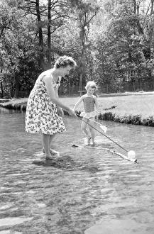 Stream Prints: A little girl splashes away with her mother in a stream just inside the main gate of