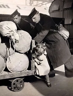 00204 Prints: Little Jean Butcher age 3 gives two sailors a hand to push the barrow containing their