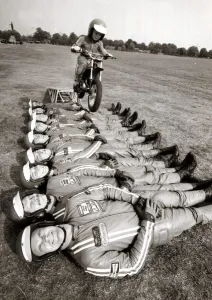 00203 Prints: Little John Shipley leaps over 9 men on his motorcycle - 1976 Motor Cycles - Stunts