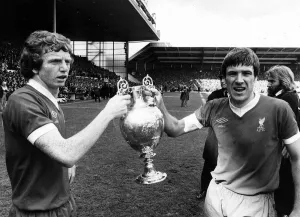 Liverpool captain Emlyn Hughes and David Fairclough celebrate with the League
