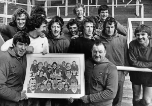 1979 Prints: Liverpool captain Emlyn Hughes presents the painting to his manager Bob Paisley as other