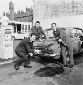 Liverpool centre half and captain Ron Yeats fills the tank of his teammates Ian St John