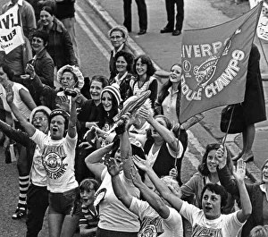 Liverpool FC fans wait to cheer their team in the city centre to celebrate their historic