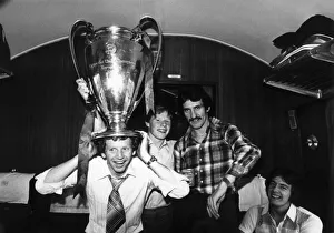 Liverpool FC player David Fairclough with the European cup on his head on the train