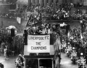 Celebrating Prints: The Liverpool FC Tour Bus passes through Liverpool City Centre as the players enjoy a