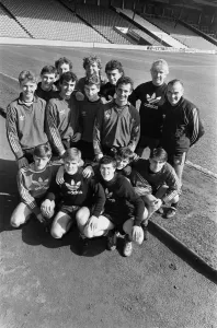 Liverpool Football Club youth squad pose at Anfield with their coaches Chris Lawler
