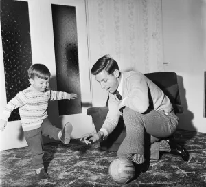 Toddler Prints: Liverpool football star Gordon Milne gives a coaching lesson to his young son Andrew