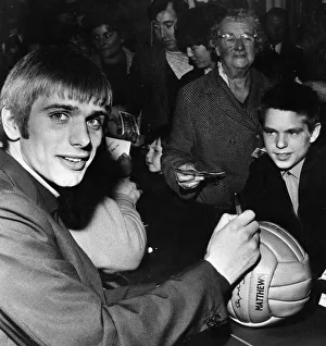 Liverpool footballer Alun Evans signing a football for fans. Circa 1969