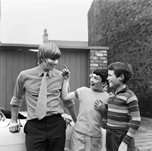 Injury Prints: Liverpool footballer Alun Evans speaks to two young fans who inspect his damaged eye as