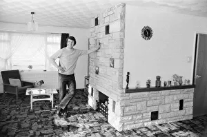 Fireplace Prints: Liverpool footballer Chris Lawler poses at his home in Knowsley near Liverpool