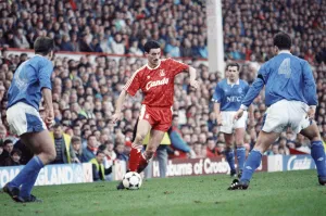 Surrounded Prints: Liverpool footballer Ian Rush in match against Merseyside rivals Everton during the derby